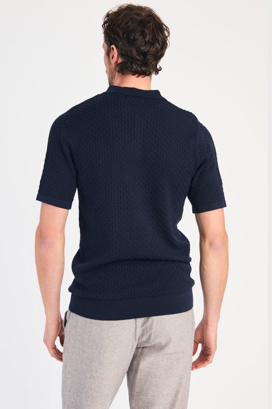 Dark Navy Cotton Short Sleeve Button-Up Polo Shirt This textured polo shirt from Nines Collection blends classic sophistication with modern design. Crafted from a premium cable fabric with a subtle pattern, it offers a refined yet contemporary look. Lightweight and breathable, it’s a versatile choice for smart-casual occasions, ensuring style and comfort effortlessly. Made from 100% Cotton.
