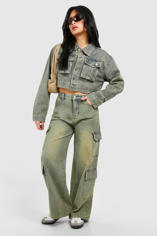 Wide leg cargo jeans with vintage wash effect
        Multiple utility pockets for added functionality
        Cropped jacket with matching wash and pocket details
        High-waisted design for a flattering silhouette
        Relaxed fit through legs for comfort and style
    
    Make a bold statement with these eye-catching cargo jeans, perfect for the fashion-forward trendsetter. The wide-leg silhouette offers a contemporary twist on a classic denim style, whilst the vintage wash adds character and depth. Pair with the coordinating cropped jacket for a head-turning denim-on-denim ensemble that's sure to turn heads. For a casual daytime look, team with a simple white crop top and trainers. Dress it up for evening drinks by swapping trainers for heeled boots and adding statement jewellery. These versatile jeans are ideal for various casual occasions, from weekend brunches to music festivals. The multiple pockets not only add to the utilitarian aesthetic but also provide practical storage for your essentials. Embrace the Y2K revival trend and make these cargo jeans your go-to piece for effortless, street-style inspired outfits.
