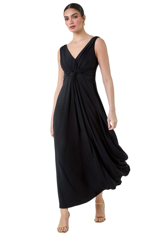Plain Knot Front Maxi Dress from Roman. Turn heads in this luxuriously elegant knot front maxi dress. This exquisite sleeveless dress features a flattering v-neckline and a striking v-back detail, ensuring you make a sophisticated statement. With a fit and flare silhouette, this plain dress is fitted at the waist and flows into a floor-sweeping length, perfect for special occasions. The stretch jersey fabric drapes beautifully, while the knot detail at the waist adds an extra touch of glamour. Whether you're attending a wedding reception or a formal dinner, pair with strappy heels and a fascinator for a Summer wedding look.
