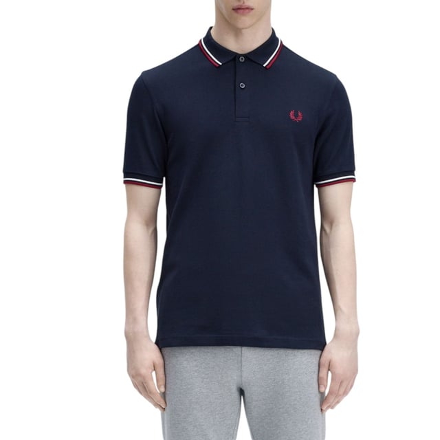 The Twin Tipped Fred Perry Polo Shirt by Fred Perry is a short sleeved polo shirt that has been made from Fred Perry's classic cotton piqué, in a contemporary adaptation of Fred's famous streamlined fit. Available in a diverse range of colourways - each with their own unique story. Featuring the signature Fred Perry wreath logo to the chest and twin tipping to the collar and cuffs.