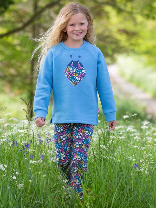 100% organic cotton | Proud to be certified to the Global Organic Textile Standard (GOTS) | Ladybird appliqué design featuring our flower patch print | OEKO-TEX Standard 100 (Product class I) appliqué backing | Cornflower blue | Brush back sweat fabric 3 ply (290-300 gsm) | Coconut button raglan sleeve opening (up to and including size 3 years) | Long sleeved | Round neck | Ribbed neckline and cuffs | Made in Turkey | Machine washable at 40 degrees, or at 30 degrees to be kinder to the planet