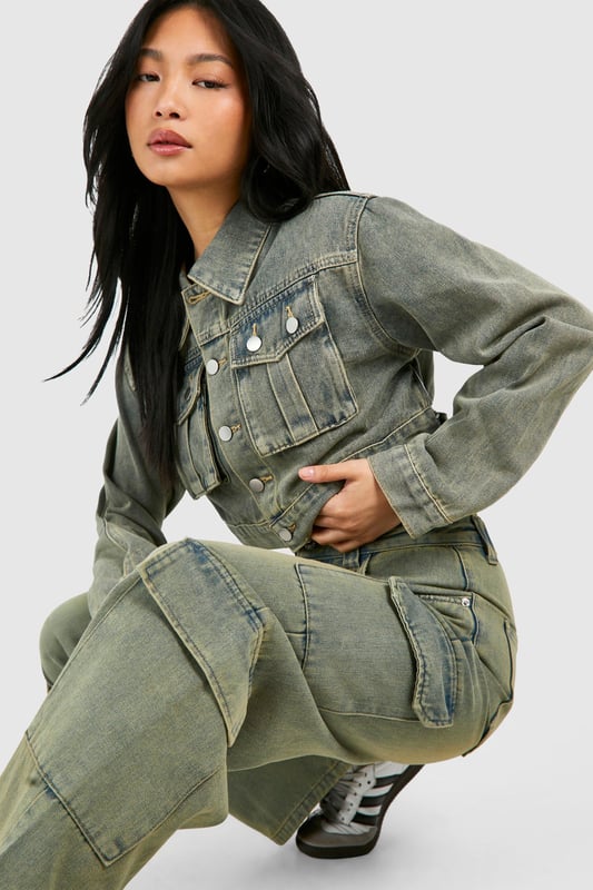Wide leg cargo jeans with vintage wash effect
        Multiple utility pockets for added functionality
        Cropped jacket with matching wash and pocket details
        High-waisted design for a flattering silhouette
        Relaxed fit through legs for comfort and style
    
    Make a bold statement with these eye-catching cargo jeans, perfect for the fashion-forward trendsetter. The wide-leg silhouette offers a contemporary twist on a classic denim style, whilst the vintage wash adds character and depth. Pair with the coordinating cropped jacket for a head-turning denim-on-denim ensemble that's sure to turn heads. For a casual daytime look, team with a simple white crop top and trainers. Dress it up for evening drinks by swapping trainers for heeled boots and adding statement jewellery. These versatile jeans are ideal for various casual occasions, from weekend brunches to music festivals. The multiple pockets not only add to the utilitarian aesthetic but also provide practical storage for your essentials. Embrace the Y2K revival trend and make these cargo jeans your go-to piece for effortless, street-style inspired outfits.