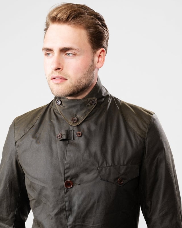 Barbour Beacon Sports Wax Jacket
As this is a slim fitting jacket, we would advise purchasing the next size up than you would normally choose. The three-pocket waxed Beacon Sports jacket is an iconic blazer-style button through, inspired by the sought-after, limited edition To Ki To Sports Jacket. Effortlessly stylish and easy to wear, the Beacon Sports Jacket is a mediumweight waxed cotton jacket featuring soft leather-bound cuff edges, shoulder and elbow patches, two zipped rear pockets and a button-up throat flap. Lined with Barbour tartan, this jacket reflects traditional Barbour elements, with classic hip-height bellows pockets and a single chest pocket. This jacket is surprisingly versatile, and looks great worn as a blazer with the collar folded down and lapels open, or with the collar turned up worn over a fine-knit jumper and scarf for a contemporary country look.

Tailored Fit
Barbour tonal embroidery to left pocket
Outer: 100% cotton (waxed)
Lining: 100% cotton
Trim: 100% wool
6oz waxed cotton
Do not wash
Sponge clean only
Back length: 69cm - 81.5cm

MWX0007