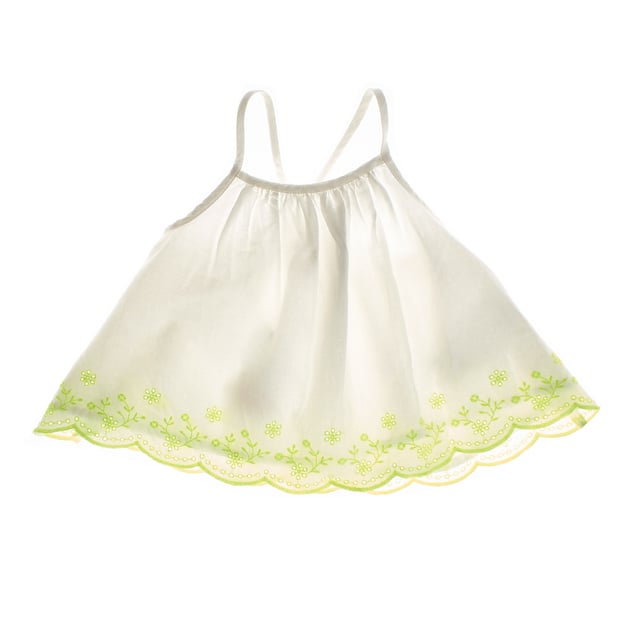 Girl's top with a delicate and fresh design, perfect for summer days.

 With thin straps that cross at the back, it adds a subtle and elegant touch.

 The bottom edge is decorated with charming floral embroidery and scalloped finish, providing a handcrafted and feminine detail.

 Its wide, loose cut allows for a light and comfortable fall, ideal for combining with other garments for a casual and airy look.
 Composition: Exterior: 100% Cotton; Interior: 100% Cotton; Embroidery: 100% Cotton
 Care:
- Machine wash max. 30ºC..
 - Use similar colors in the wash.
 - Avoid the use of bleaches.
 - Dry at low temperature.
 - Iron at low temperature.
 - Do not dry clean.