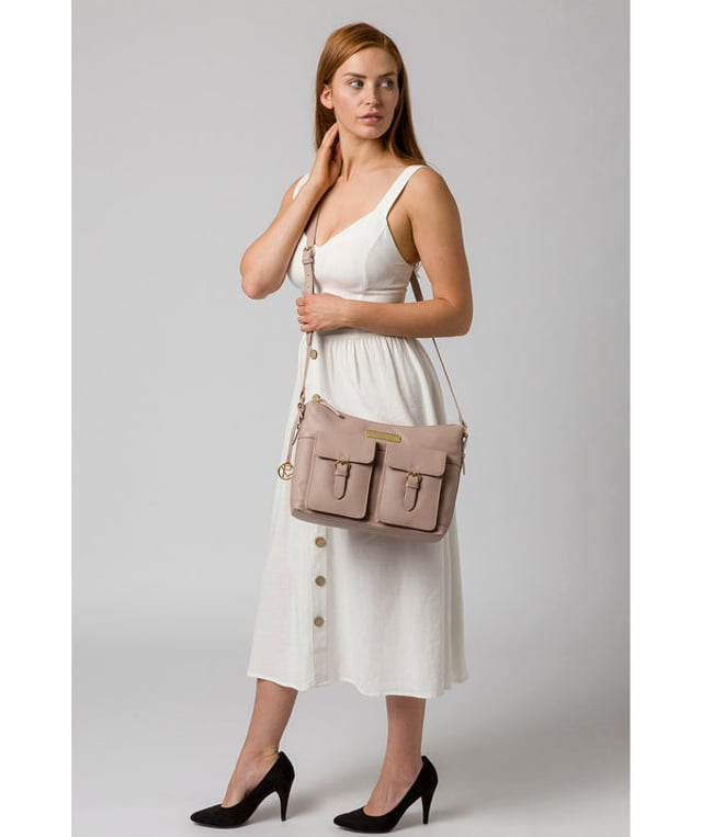 Crafted from leather that has soft pebble grain finish, the 'Jenna' shoulder bag from Pure Luxuries London comes with eye-catching gold-coloured fittings. The zip-over top secures a 100% cotton lined compartment, complemented by two internal pockets along with three external pockets that provide on-the-go storage; two of which are fastened with mock buckle press-studs. Comes with an adjustable matching leather strap and is adorned with the gold-coloured Pure Luxuries London charm and logo.