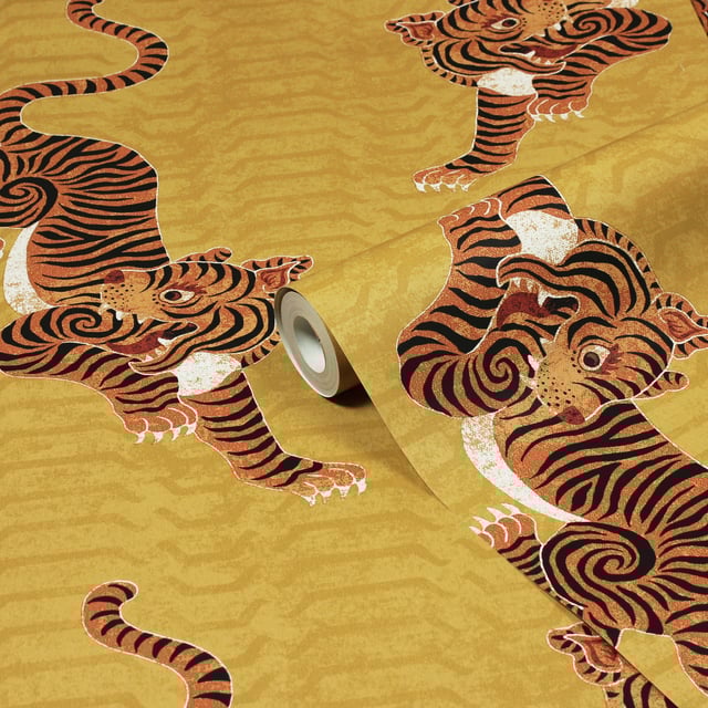 Add instant personality into your home with this showstopping Tibetan Tiger wallpaper featuring a tribal-inspired design and crawling tigers. The striking orange tiger contrasts on a bold mustard backdrop, adding dimension and flair to this beautiful wallpaper. This wallpaper is a paste the wall application; simply paste the wall, hang your paper, and leave to dry. Each roll is 10m long and 52cm wide. Pattern repeat: 53cm Straight Match. Our Tibetan Tiger wallpaper can be used to paper the whole room or to create an eye-catching feature wall. This wallpaper is also wipeable so that any light marks can be dabbed away.