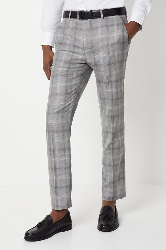Slim fit tailored trousers with a sleek, tapered silhouette
Crafted from a fine grey check patterned fabric
Flat front styling with slant side pockets
Belt loops to accommodate a smart leather belt
Hem designed to sit neatly on the shoe

Exuding refined sophistication, these slim fit trousers from Burton are the epitome of smart tailoring. Pair them with a crisp shirt and blazer for a polished look at formal occasions or dress them down with a knitted jumper for elevated weekend styling. The slim cut flatters the frame while the grey check pattern adds a touch of classic British flair, making them a versatile choice for the modern gentleman's wardrobe.