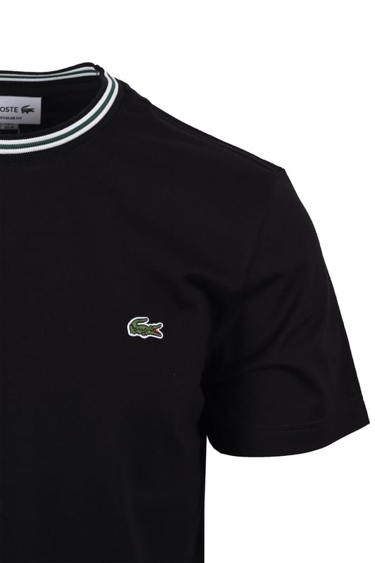 Lacoste Tipped T-shirt Black

Upgrade your everyday style with this classic black Tipped T-Shirt from Lacoste. Stylish, breathable, and versatile, this short-sleeved essential is perfect for any occasion, from weekend outings to your daily commute. It's sure to become your new go-to staple.
 
Features

Classic Lacoste Design: Showcasing the iconic Lacoste branding, this t-shirt exudes timeless style.   
Intricate Detailing: The tipped trims add a touch of sophistication and visual interest.   
Premium Quality: Crafted from 100% breathable cotton, ensuring all-day comfort.   
Versatile Style
Style code: TH9903