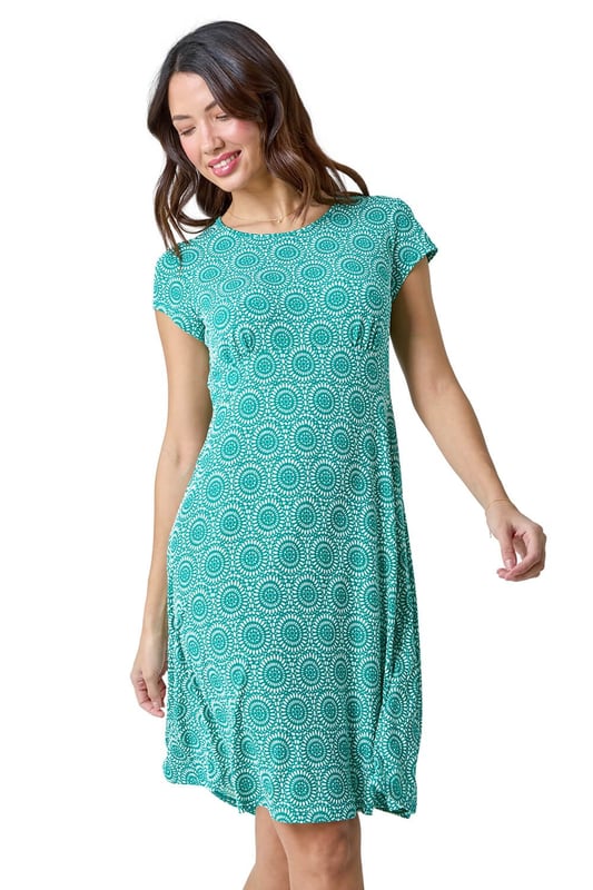 Mosaic Puff Print Gathered Dress from Roman. Introducing our texture mosaic print dress - a perfect choice for the Summer season. This dress features a classic round neckline and short sleeves for a timeless appeal. The all-over print adds a playful touch, and cut to a knee length, it's both stylish and versatile. Crafted from comfortable jersey fabric, it guarantees a relaxed yet chic look. With no fastening needed, slip into effortless style. Complete your ensemble with espadrilles and a stylish handbag for a casually elegant outfit that transcends age.
