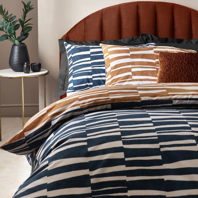 Go to sleep in style with the Piper duvet cover set, inspired by modern, minimalist and abstract art. Create an impact with this modern design, adorned with striking irregular stripes in a tone reminiscence of dusk skies. The reverse features a coordinating print in warming bronze, to offer an alternative design when you need a midweek refresh. A thoroughly modern classic, with a forward-thinking design which will add sophisticated style to your interior. This product is certified by OEKO-TEX® showing it has been sustainably made.