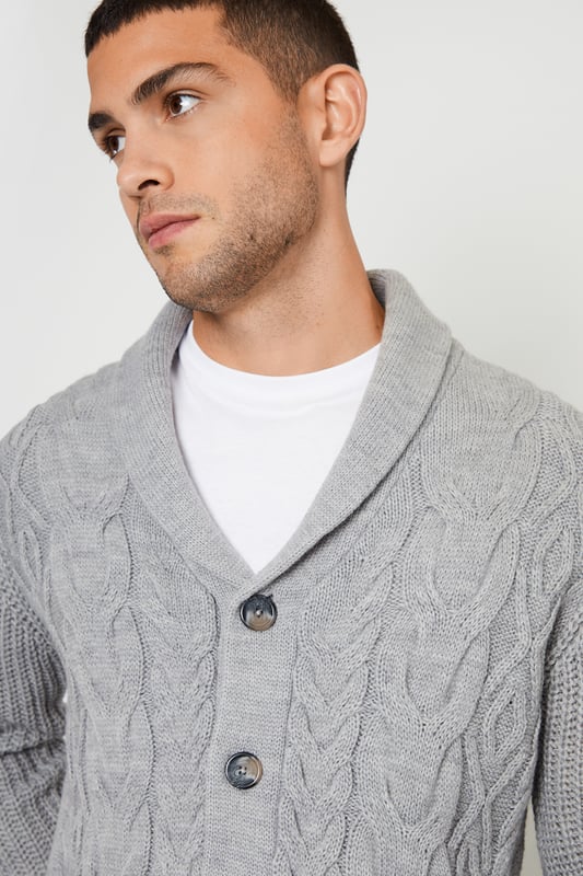 Upgrade your knitwear with this shawl collar knitted cardigan from Threadbare. With a stylish shawl collar and in a cable knit design, this jumper has ribbed cuffs and hem for comfort and full mock horn button fastening. Finished with two side welt pockets and the Threadbare metal branding tab on the hem. A great piece to have on hand for layering when the temperature drops. Pair with dark denim jeans and layer over a white tee for a stylish casual look.
