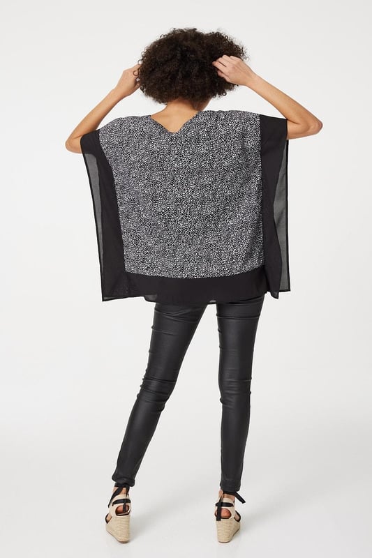 Make a statement with this leopard print poncho blouse top. It has a round neck, short sleeves, an oversized fit and a thigh length hem. Pair with fitted trousers and heeled wedges for a standout style that's perfect for date night or drinks with the girls.