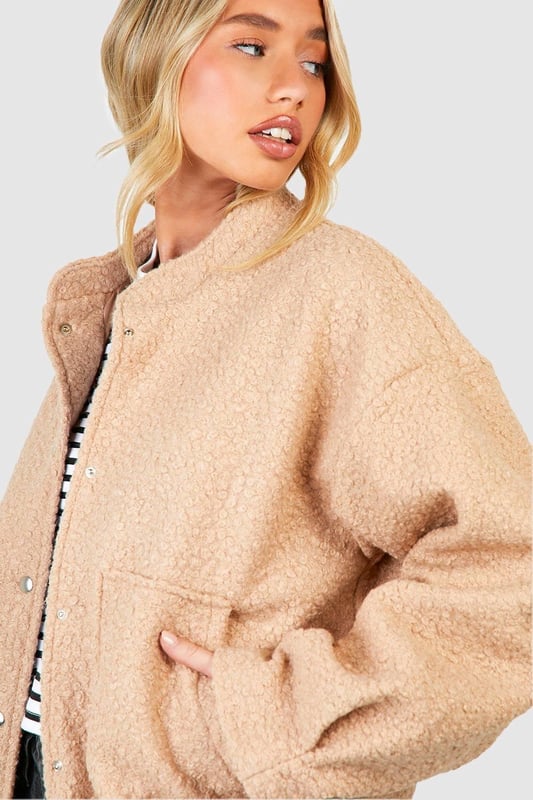 Keep things casual but always on-trend with a piece of outerwear perfection, the bomber jacket. A light jacket featuring a gathered, ribbed waistband and matching cuffs, a bomber jacket is versatile, timeless, and the perfect way to edge up your casual wear. Wear your new women's bomber jacket with a shirt and stripe joggers for the hottest look of the moment: sports luxe, or layer a varsity jacket over a t shirt dress for a fresh new-season look.Style: Bomber JacketFabric: Wool LookLength: RegularSleeve Length: Long Sleeve