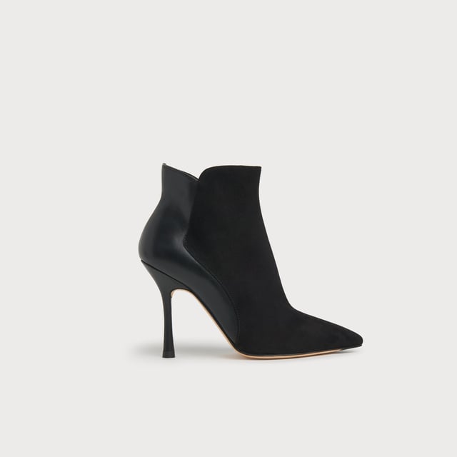 A sexy new style in our autumn/winter shoe collection, our Aliyah ankle boots have incredible shape. Crafted in Spain from a stylish blend of black suede and nappa leather, they have pointed toes, inside zips and 100mm slender heels with flared detail. Sophisticated and stable, wear them with autumn's midi dresses and sleek tailoring alike.