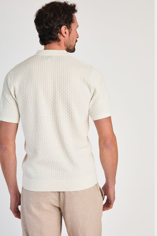 This textured polo shirt from Nines Collection blends classic sophistication with modern design. Crafted from a premium cable fabric with a subtle pattern, it offers a refined yet contemporary look. Lightweight and breathable, it’s a versatile choice for smart-casual occasions, ensuring style and comfort effortlessly. Made from 100% Cotton.