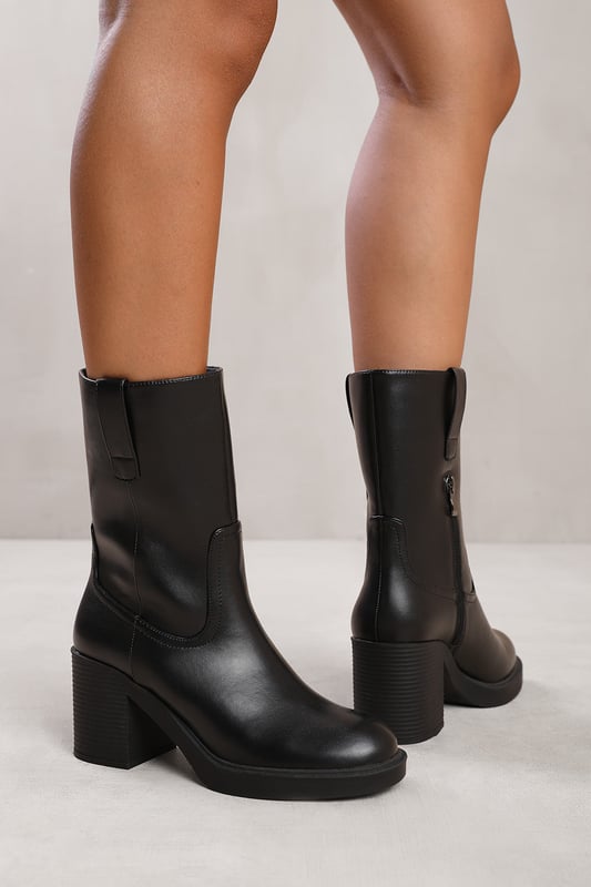 Wheres That From Womens 'Beau' Mid Calf Boot With Side Zip Make a bold fashion statement with our Beau Mid Calf Boot with Side Zip. These boots combine style and functionality, offering a unique and trendy addition to your shoe collection.Key Features:
Chunky Design: The chunky design of these boots adds a touch of edginess and flair to your outfit. The chunky sole and heel provide stability and support while giving you a confident and fashion-forward look.
Mid-Calf Length: The mid-calf length of these boots offers a balance between coverage and style.
Side Zip: The side zip closure makes these boots easy to put on and take off. The side zip adds convenience. This also adds a stylish and modern touch to the overall design.
Specifications:
Material: Faux Leather
Design: Chunky Chelsea mid-calf boots with side zip
Heel Height: 2.3' (5.8cm) approx
Boot Height: Mid-calf
Closure: Side zip closure for easy wear
Step up your fashion game with our Beau Mid Calf Boot with Side Zip. These boots offer a combination of style, comfort, and versatility, ensuring you make a lasting impression wherever you go. Embrace the chunky heel trend with these trendy and fashionable boots.