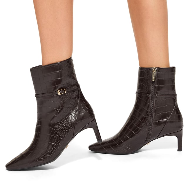 This KG Kurt Geiger Impress Ankle Boot features a brown croc embossed upper. There is a thin ankle strap around the ankle with gold tone buckle. Heel height: 6cm.