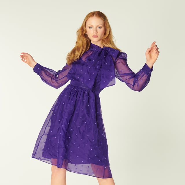 A vibrant play on our vintage-inspired Glinda pieces, Depp takes on the spotty organza in striking violet. Crafted from fine silk organza in purple dotted with purple embroidered spots, this long-sleeve dress has a round neck finished with an oversized bow, a slip layer, a nipped waist and a full skirt. Wear it with sharp courts and a clutch when those dressing up moments call.