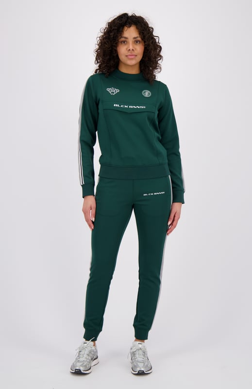 100% Polyester Elastischer Hosenbund mit Kordelzug Reißverschlusstaschen BLCK BNNS am rechten Bein Sportliches Streifenband an den Seiten Kombinierbar mit MIAMI TAPED TRACKTOP 