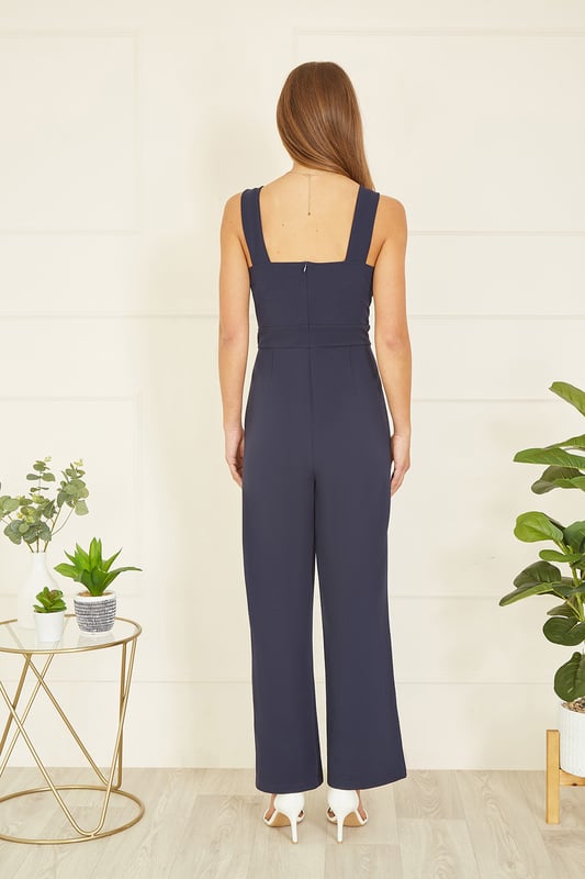 Stay bang on trend at any invite this season in this Mela jumpsuit. The all in one design has been crafted from a stretch fabric to ensure you can be mega stylish and comfortable for those all day events. With a wrap over neckline, and gold buckle details on the straps, finish this flattering wide leg fit with a pair of heels.