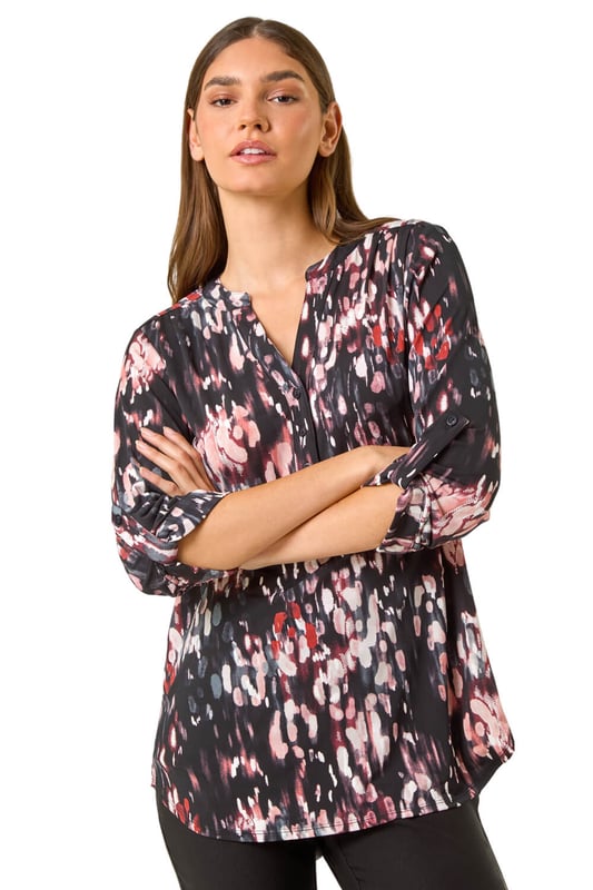 Textured Abstract Print V-Neck Stretch Top from Roman. Unleash your signature style this Autumn Winter with our abstract print shirt. Designed in a soft, stretchy jersey fabric, this shirt features a striking 3D abstract puff print for an eye-catching look. The flattering v-neckline adds a touch of sophistication, while the shoulder pleat details, front button fastenings, and 3/4 length tabbed sleeves create a trendy finish. Style with jeggings and ankle boots for both casual and smart occasions!