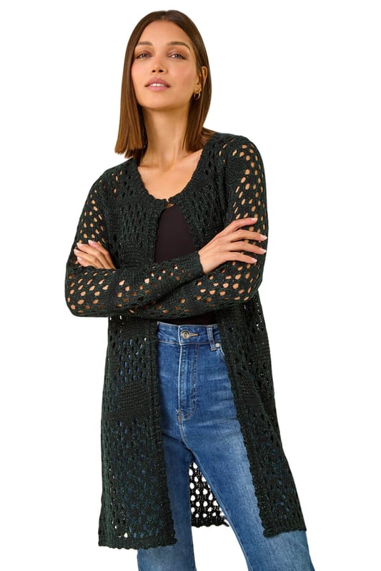 Shimmer Longline Knit Cardigan from Roman. Add a touch of shimmer to your Autumn wardrobe with this stunning longline cardigan. Featuring intricate stitch details, this cardigan is designed with long sleeves and a unique hook and bar fastening at the neck. The shimmer effect adds a touch of elegance to any outfit. Pair it with jeans and sandals for a casual yet chic look that will sparkle all season long!