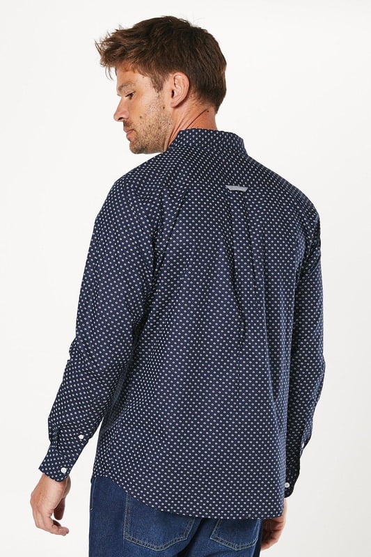 Striking geometric print for a modern twist on classic shirting
        Button-down collar for a smart-casual look
        Long sleeves with adjustable cuffs for versatile styling
        Chest pocket adds a functional touch
        Regular fit allows for comfortable movement
    
    This Maine geo print long sleeve shirt is a versatile addition to any wardrobe, perfect for those seeking a balance between style and comfort. The eye-catching geometric pattern adds interest to your ensemble without overwhelming it, making it suitable for various casual occasions. Pair it with your favourite jeans and trainers for a relaxed weekend look, or dress it up with chinos and loafers for a smart-casual dinner out. The cotton fabric ensures breathability and ease of care, ideal for the busy modern man. Layer it under a jumper on cooler days or wear it open over a plain t-shirt when the weather warms up. Whether you're heading to a family gathering, meeting friends at the pub, or enjoying a casual day at the office, this shirt will keep you looking effortlessly stylish.