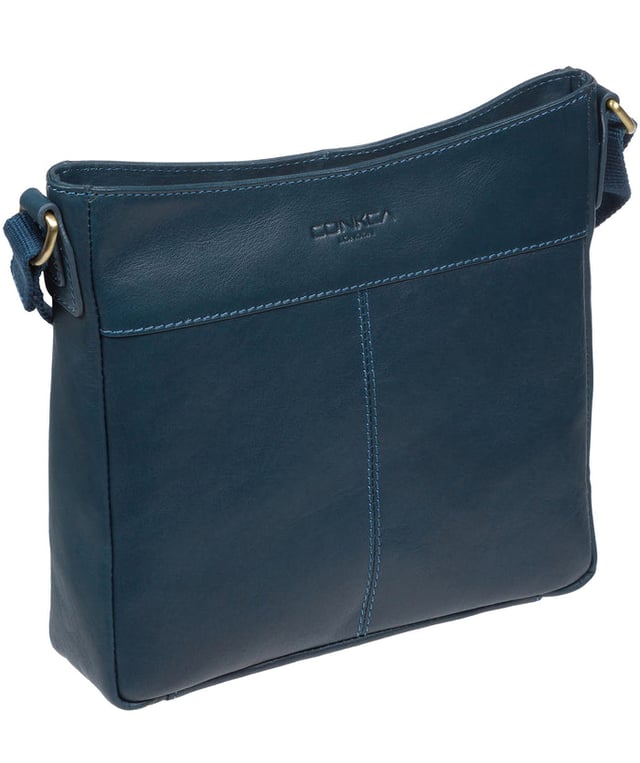 The 'Baby Bon' cross body bag from Conkca London is handcrafted from full grain genuine leather for a beautiful finish. A smaller version of the original 'Bon' cross body bag. A zip-over top conceals the central compartment that is lined with natural and untreated 100% cotton. The zipped pocket and two pockets secured with magnetic fastenings on the front of the bag, provide plentiful on-the-go storage. Comes with an adjustable fabric strap with a maximum drop length of 70cm. Adorned with the inimitable Conkca squirrel charm and embossed logo.