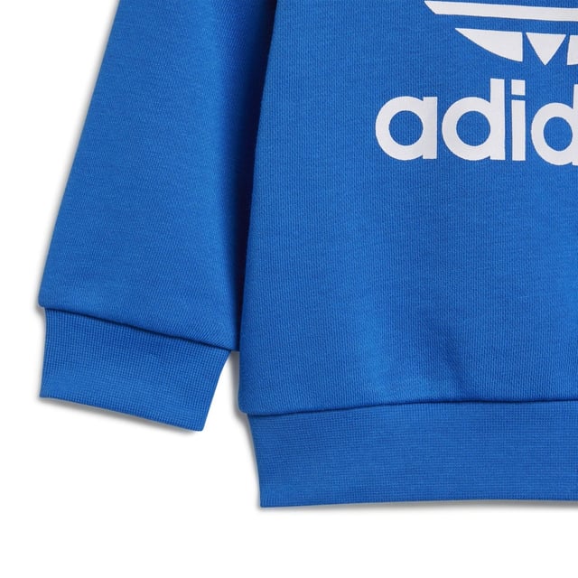 Dress them up in iconic sporty style. A big contrast Trefoil logo and 3-Stripes give this infants' outfit an authentic look. Both pieces are made of a cosy  soft French terry. Hidden shoulder snaps on the sweatshirt make it easy to slip on and off.Ribbed crewneckLong sleeves with ribbed cuffs; Ribbed pants cuffsRegular fit is not tight and not loose  the perfect in-between fit70% cotton  30% polyester (recycled)