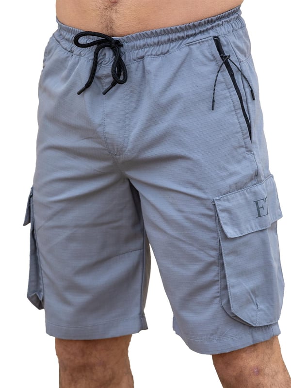 Expertly designed with top-quality ripstop fabric, these Enzo technical cargo shorts offer unparalleled durability. The convenient cargo pockets and zip side pockets make for easy storage, and the elasticated waistband with an adjustable drawstring ensures a comfortable fit. Upgrade your wardrobe and gear with this must-have for any outdoor enthusiast.