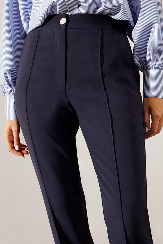 Tapered fit for a sleek silhouette
        Elegant split hem detail
        High-waisted design for a flattering fit
        Versatile style suitable for smart and casual occasions
        Comfortable stretch fabric for all-day wear
    
    These split hem tapered trousers from Wallis are the epitome of sophisticated style with a modern twist. The tapered fit creates a streamlined look that flatters your figure, while the split hem adds a touch of contemporary flair. Perfect for the woman who values both comfort and elegance, these trousers can effortlessly transition from day to night. Pair them with a crisp button-down shirt and blazer for a polished office ensemble, or dress them down with a silk blouse and statement jewellery for evening drinks. The high-waisted design not only accentuates your waistline but also provides a smooth foundation for tucked-in tops. Whether you're attending a formal event or aiming for a smart-casual look, these versatile trousers will ensure you always look put-together and feel confident.