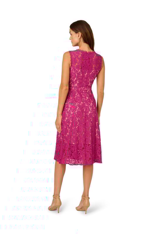 Dressy by day, flirty by night, this lace dress is a charming look. This fit and flare dress features a crew neckline, sleeveless bodice with sheer lace at the yoke, and a belted waist. Partially lined with contrasting fabric, this midi dress is crafted from lace that is sheer at the neck and hem. This party dress is closed with a zipper at the centre back. Complete the look for a day at the office or a night out with nude heels and sparkling jewels.