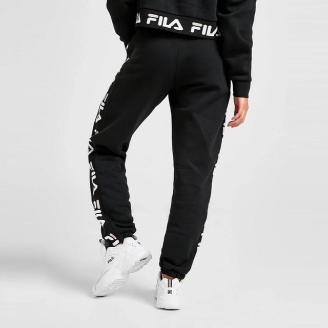 Fila Womens Jacquard Panel Joggers in a Black. 
These Soft Pants have a Luxe Feel to Them While Offering Ultra Comfort. 
These Joggers Have Elasticated Cuffs with Waistband for a Perfect Fit. 
Finished With a White and Black Fila Taping Down Both Legs and a Fila Logo to the Thigh. 
80% Cotton, 20% Polyester. 
Machine Washable.