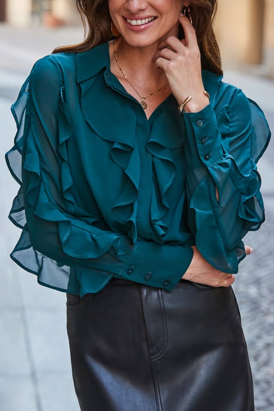 Guaranteed to spark joy Statement ruffles make it so fun to wear Cut for a comfy relaxed fit It'll take you from desk to dinner We love it with kick-flare trousers or jeans Dial up the glamour with jewelled earrings