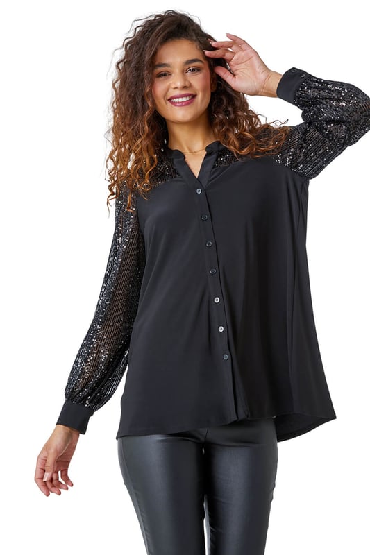 Sequin Embellished Detail Blouse from Roman. Be life and soul of the party with this sequin embellished blouse. Created with a notch neckline and sequin embellishment along the shoulders and sleeves, this top makes for the perfect party piece. Finished with buttoned cuffs, this stretch, jersey piece is sophisticated, stylish and comfortable. Pair with faux leather trousers and heels and get ready to dance the night away!