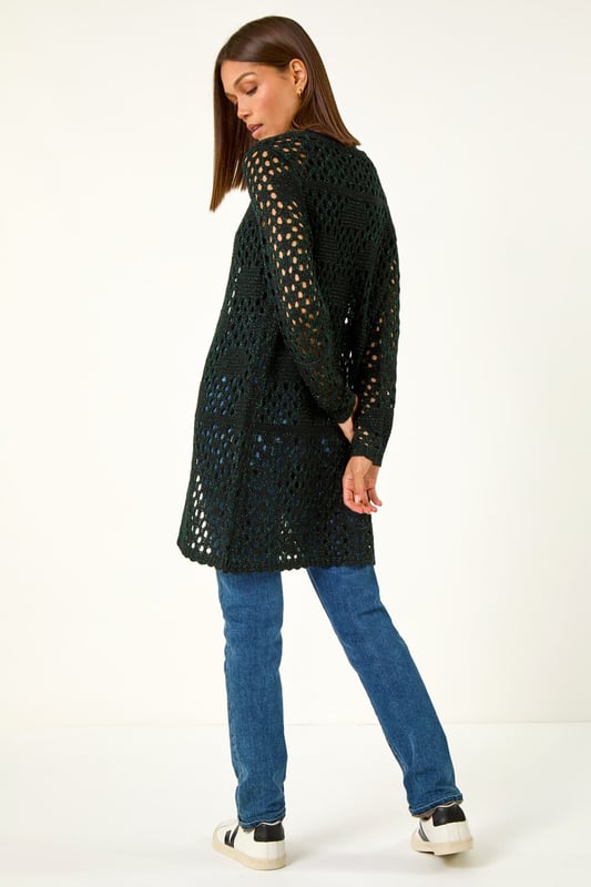 Shimmer Longline Knit Cardigan from Roman. Add a touch of shimmer to your Autumn wardrobe with this stunning longline cardigan. Featuring intricate stitch details, this cardigan is designed with long sleeves and a unique hook and bar fastening at the neck. The shimmer effect adds a touch of elegance to any outfit. Pair it with jeans and sandals for a casual yet chic look that will sparkle all season long!