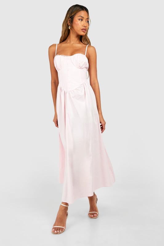 Sweetheart neckline for a feminine touch
        Adjustable spaghetti straps for a customised fit
        Fitted bodice with ruched detailing
        Flowy midi-length skirt for effortless movement
        Versatile design suitable for various casual occasions
    
    This charming midi dress from Boohoo is the perfect addition to your summer wardrobe. The sweetheart neckline and ruched bodice create a flattering silhouette, while the flowy skirt adds a touch of romance to your look. Style it with strappy sandals and a woven bag for a laid-back daytime ensemble, or dress it up with wedges and statement earrings for a garden party. The adjustable straps ensure a comfortable fit, making it ideal for long days out or family gatherings. This dress embodies the carefree spirit of summer, allowing you to look effortlessly chic whether you're brunching with friends or attending a casual outdoor event. Its versatility makes it a wardrobe staple that you'll reach for time and time again.