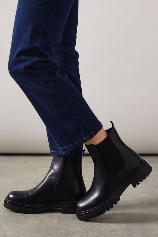 Chunky Chelsea ankle boot design
        Faux suede upper for a soft, luxurious feel
        Elastic side panels for easy slip-on
        Sturdy cleated sole for enhanced grip
        Low heel height between 2.5 and 4.5cm for comfortable wear
    
    The Melba Chunky Chelsea Ankle Boot from Oasis is a versatile staple that will carry you through the seasons with ease. These boots strike the perfect balance between style and practicality, featuring a classic Chelsea boot silhouette with a modern twist. The chunky cleated sole adds an edgy element to your look while providing excellent traction for various terrains. Pair these boots with your favourite skinny jeans and an oversized jumper for a cosy weekend brunch, or style them with a flowy midi dress and leather jacket for a night out with friends. The low heel ensures all-day comfort, making these boots ideal for city exploring or casual gatherings. Their timeless design means they'll complement a range of outfits, from relaxed daywear to smart-casual ensembles, making them a go-to choice for the fashion-conscious woman who values both style and comfort.
