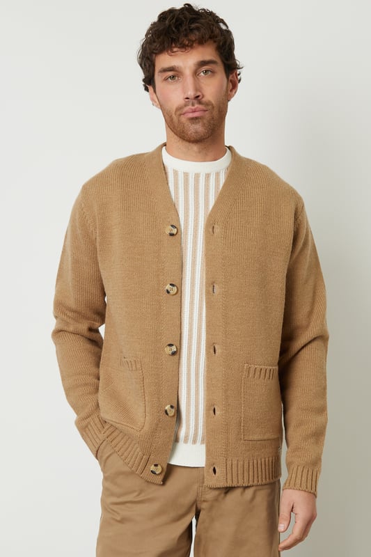 Be comfortable in style in this button down, knitted cardigan from Threadbare. With a V-neckline, ribbed cuffs and hem, this button up cardigan is the perfect addition to your wardrobe. Complete with branded metal tab above the hem, five mock horn buttons and two patch pockets. Made from a super-soft yarn with wool, this style is ideal for layering. Pair with dark denim jeans, a white t-shirt and boots for a stylish, casual look.