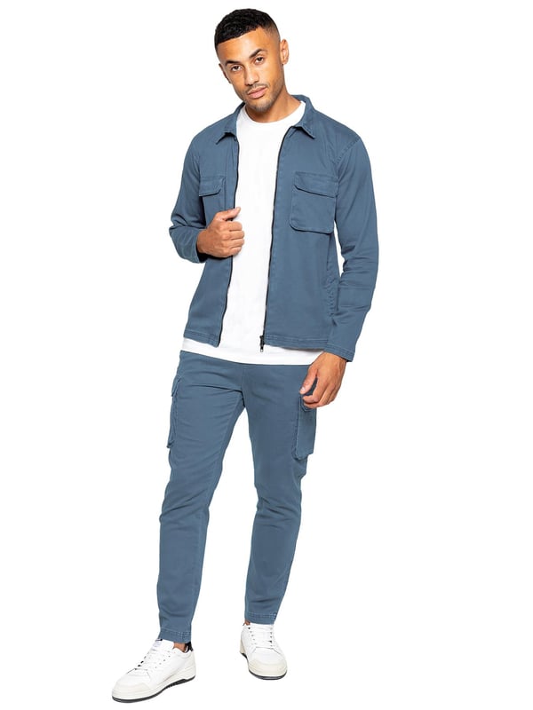 Enzo | Mens Cargo Tracksuit Set Enzo Mens Cargo Outfit Set. Long Sleeved, Zip Up, Collared, Cargo Overshirt. Two Front Flat Cargo Pocket With Velcro Fastening. Two Side Welt Pockets. Stitched Trims On Sleeves And Hemline. Set Completed With Cargo Trousers. Regular Fit, Straight Leg, Enzyme Wash. 5 Pocket Design. 2 Side Pockets, 2 Cargo Pockets With Velcro Fastening. Single Back Welt Pocket. Elasticated Waistband With Adjustable Drawstring