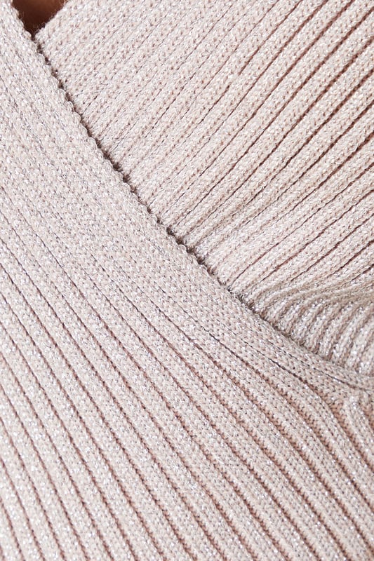 Flattering wrap neckline for a feminine silhouette
        Ribbed knit texture adds visual interest
        Long sleeves for versatile wear
        Fitted design accentuates curves
        Subtle lurex thread for a touch of sparkle
    
    This petite lurex wrap knitted top from Dorothy Perkins is a versatile piece that seamlessly transitions from day to night. The wrap neckline creates a flattering V-shape, while the ribbed texture adds depth to the overall look. Perfect for those who prefer a more modest style, this top offers coverage without compromising on trend. Style it with a leather-look skirt and knee-high boots for a chic brunch outfit, or pair it with tailored trousers for a sophisticated office ensemble. The subtle sparkle from the lurex thread makes it an ideal choice for casual evening events or family gatherings. Its fitted silhouette ensures a polished appearance, whether you're meeting friends for coffee or attending a baby shower. Machine washable for easy care, this top is a practical yet stylish addition to any wardrobe.