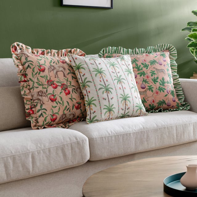 Enhance your living space with the Okara Palm Piped Cushion. Featuring a hand-painted design that juxtaposes delicate florals with bold palm tree motifs, this cushion offers a refined yet relaxed aesthetic. The textured linen-look fabric adds depth and versatility, while the piped trim provides a refined finish. With its intricately patterned reverse, this cushion effortlessly blends modern and tropical inspirations, making it an ideal accent for a variety of interior styles. Perfect for those who appreciate the beauty of nature and the charm of thoughtful design.