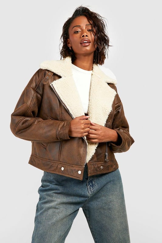 Take your outfit to new style heights with an aviator jacket. Perfect for layering, create a stylish oversized silhouette as you choose from crop belted jackets to faux fur lined options. A cross between a classic flight jacket and a leather biker, it's all about the detailing with this snug winter staple. Pair your aviator coat with high waisted mom jeans and a fierce attitude as you stroll your way through your social calendar.Style: Aviator JacketFabric: Faux LeatherSleeve Length: Long Sleeve