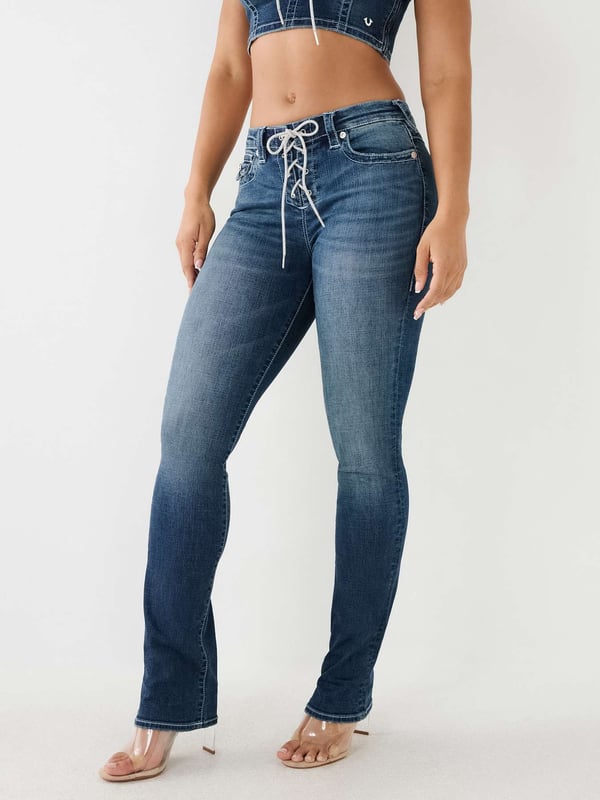 Our signature and stylish Billie gets an upgrade with a stunning front crystal lace-up closure. Our Billie Straight Jean is the perfect fit for everything. This mid rise women's straight jean features subtle fading, clean hardware, and white stitching. Finished with 1/2" horseshoe detailing along the back pockets. 