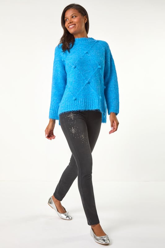 Trim Detail Jegging from Roman. Revamp your Autumn/Winter wardrobe with these embellished trim detail jeggings. These pull-on jeggings in a stretch denim fabric are designed with hotfix and stud details for a touch of sparkle and style. The unique embellishments elevate these jeggings from basic to fabulous. Perfect for a casual yet chic look, pair them with your favourite knitwear and trainers for a trendy and comfortable outfit!