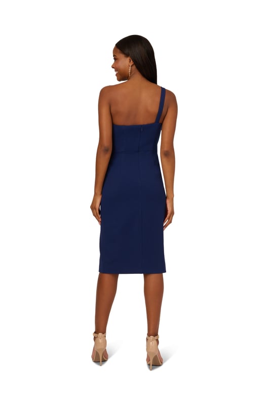 Trend-forward bow details add a fun twist to this cute short dress. This cocktail dress features a one shoulder neckline, sheath silhouette, and a bow accent at the bust with draped detailing. Designed from knit crepe fabric with some stretch, this party dress has a side slit at the skirt for easy movement. A hidden zipper closure at the side completes this one shoulder dress. Style this dress, which scales from semi-formal to formal, with nude heels and metallic accessories for a polished look.