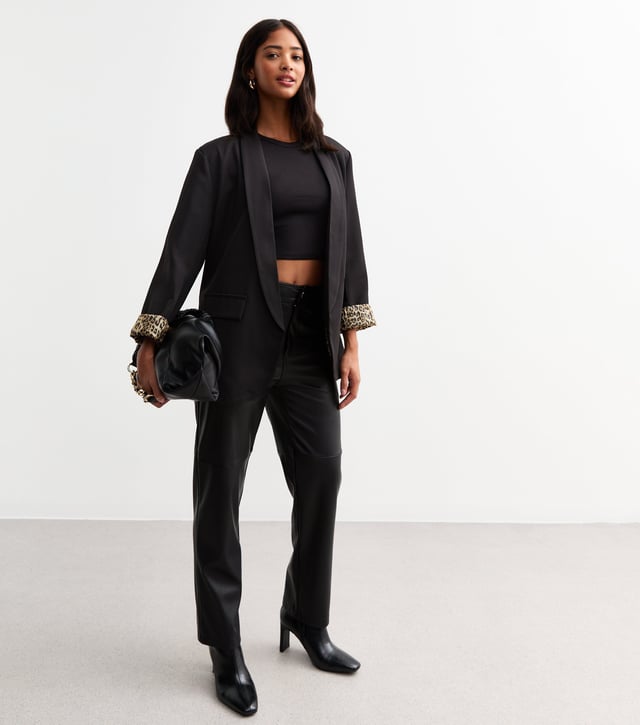 Elevate your style with our sleek Black Contrast Animal Edge to Edge Blazer. Stand out with its unique animal print contrast, perfect for the fashion-forward woman. This versatile blazer can be dressed up or down, making it a stylish addition to any wardrobe.