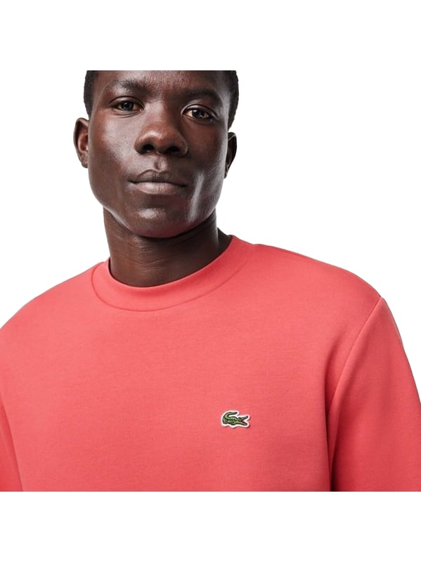 Timeless style renewed every season in a new color palette  in our signature details and a sustainable approach. Classic fit  natural ease on body with comfortable sleeves. Solid crewneck sweatshirt in brushed fleece made of organic cotton and recyled polyester. Piqué necktape in iconic Lacoste green. Embroidered 3cm green crocodile sewn on chest.