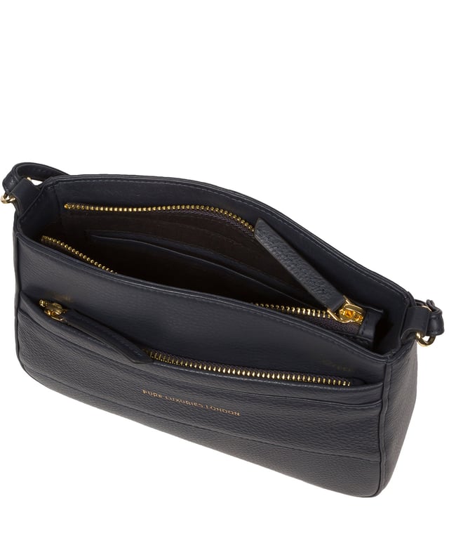 The 'Helena' cross body bag from the Pure Luxuries Marylebone collection is handcrafted from high-quality, genuine Nappa leather with a natural super-soft touch. The zip-over top opens to reveal a 100% cotton-lined interior. The spacious compartment features two slip pockets to help maintain an organised bag. A zipped pocket on the front of the bag provides on-the-go storage. Features gold-coloured metal fittings and zips alongside the adjustable slim leather strap, with a maximum drop length of 65cm. The Pure Luxuries logo is embossed in gold foil for a beautifully simple finishing touch.