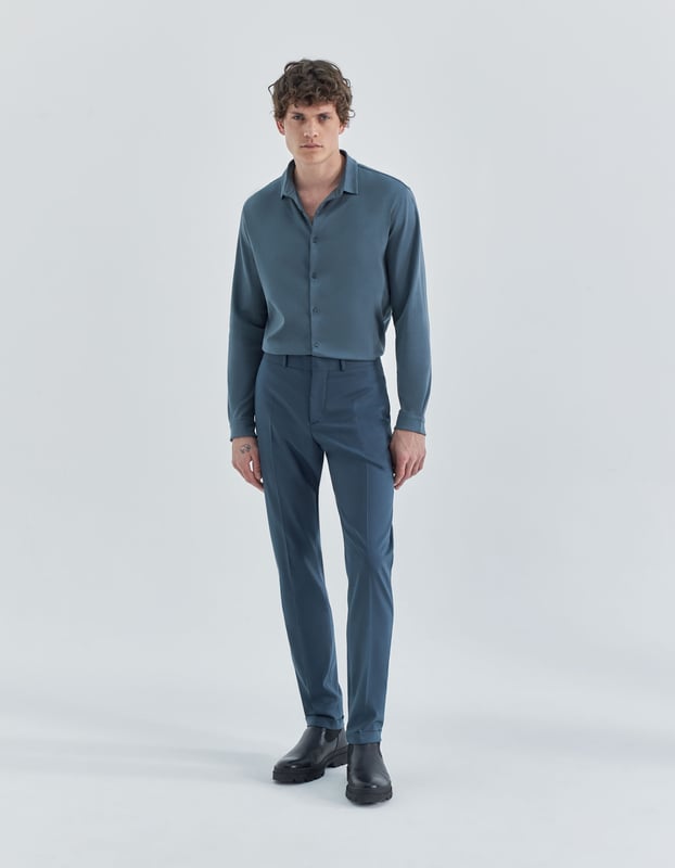 This grey trousers suit has zip and button fastening.